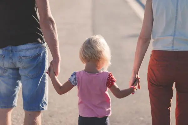 Ouders lopen met kind in hand